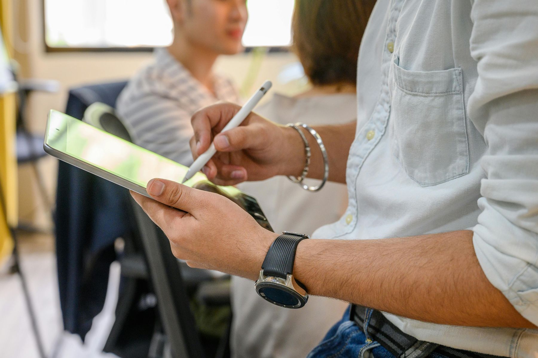 A location scout marking up notes on an iPad with a pencil