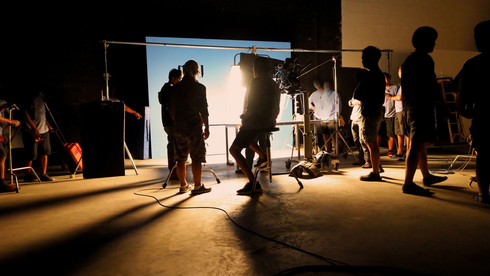 Crew and camera backlit on a film set